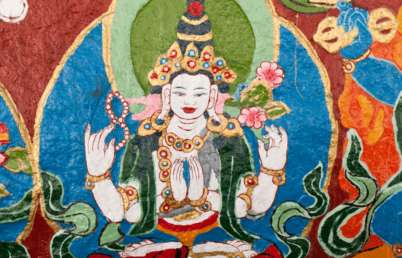 Detail of a hand-painted thangka showing a Bodhisattva