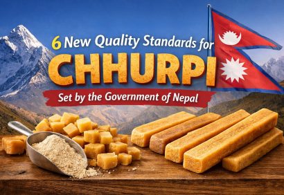 High-quality Chhurpi pieces on a wooden surface with snow-capped Himalayan mountains in the background, Nepali flag visible, representing new government quality standards for Chhurpi in Nepal.